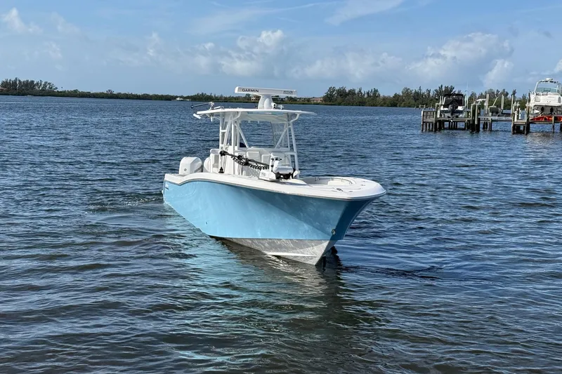 Slide: The Image of 2021 Invincible 36 CC boat on calm water, clear sky background. - 16