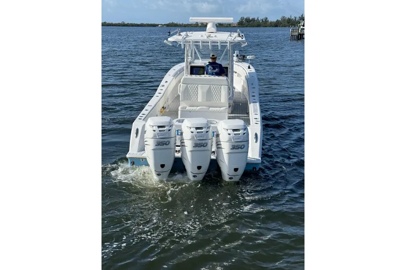 Slide: The Image of 2021 Invincible 36 CC boat with triple 350 engines on open water. - 17