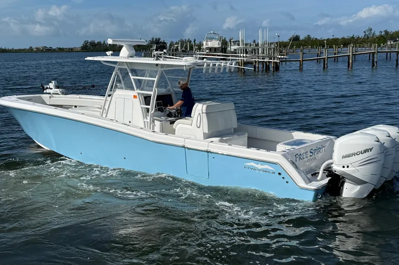 Slide: The Image of 2021 Invincible 36 CC boat with triple Mercury engines on the water. - 18