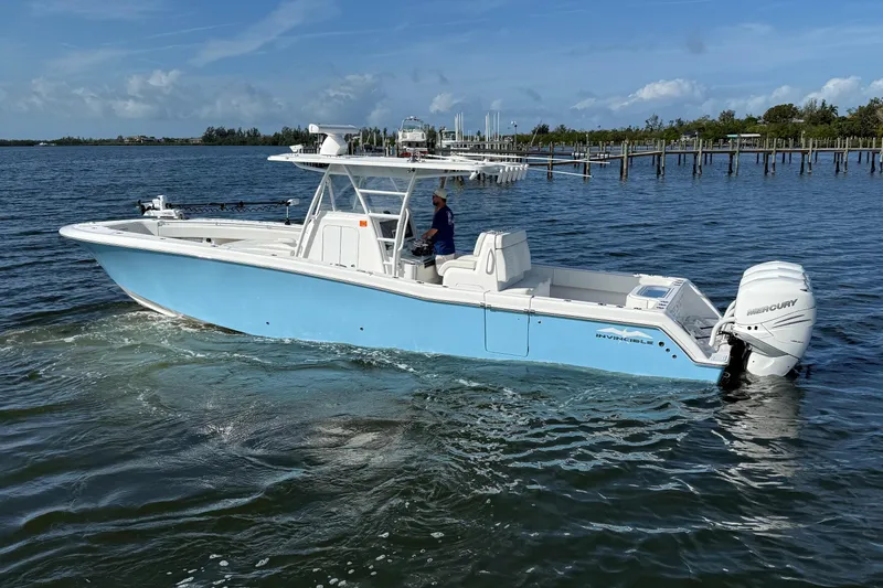 Slide: The Image of 2021 Invincible 36 CC boat on water, featuring sleek design and powerful Mercury engines. - 19