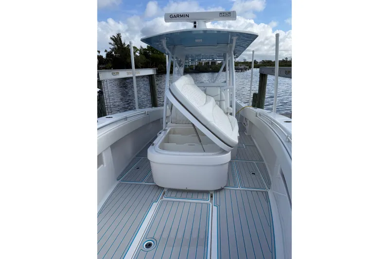 Slide: The Image of 2021 Invincible 36 CC boat with open storage, docked by the water. - 6
