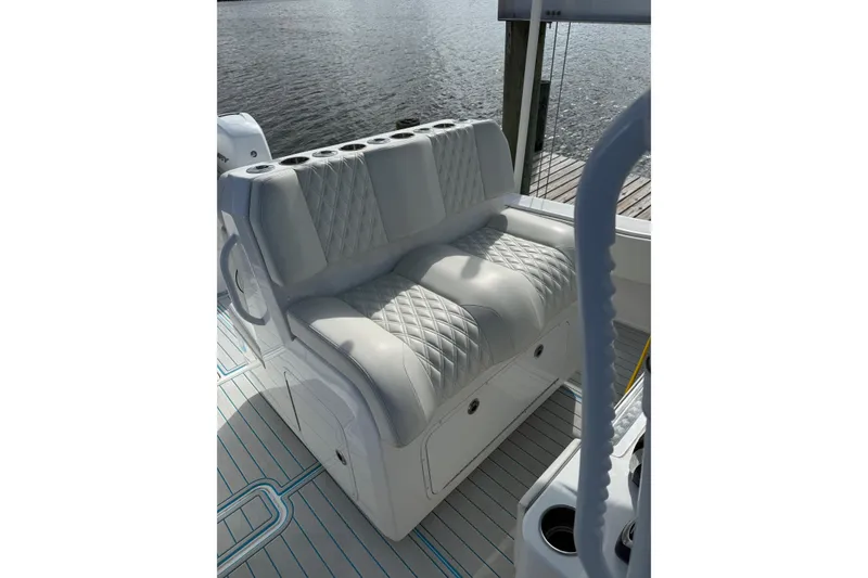 Slide: The Image of Luxurious seating on 2021 Invincible 36 CC boat, featuring diamond-stitched upholstery. - 8