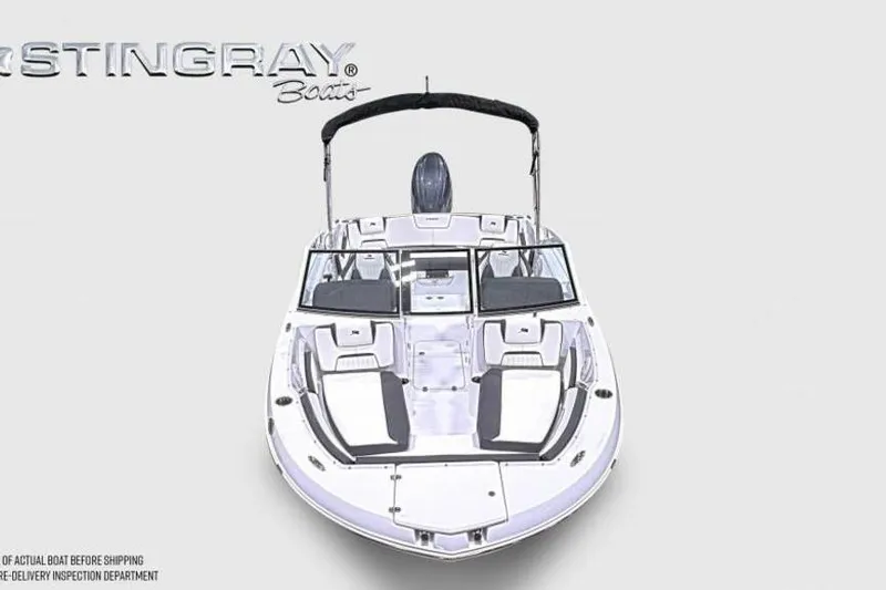 Slide: The Image of 2026 Stingray 20 SBX boat, front view, sleek design, white and black seating. - 2