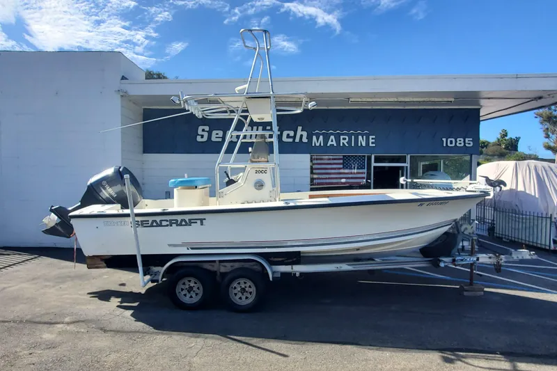 The Image of 1989 SeaCraft SC 20 Classic boat on trailer at dealership, clear sky background. - 0