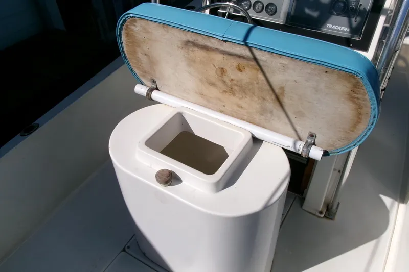 Slide: The Image of 1989 SeaCraft SC 20 Classic boat with open storage compartment and blue cushioned seat. - 19