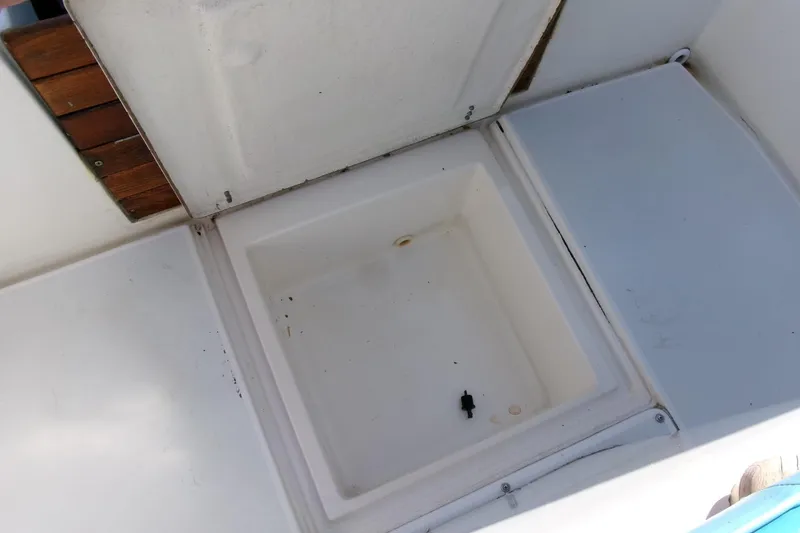 Slide: The Image of 1989 SeaCraft SC 20 Classic boat storage compartment with wooden accents. - 22