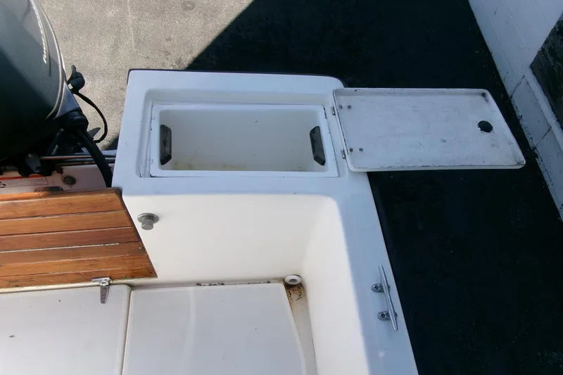 Slide: The Image of 1989 SeaCraft SC 20 Classic boat with open storage compartment and wooden deck detail. - 23