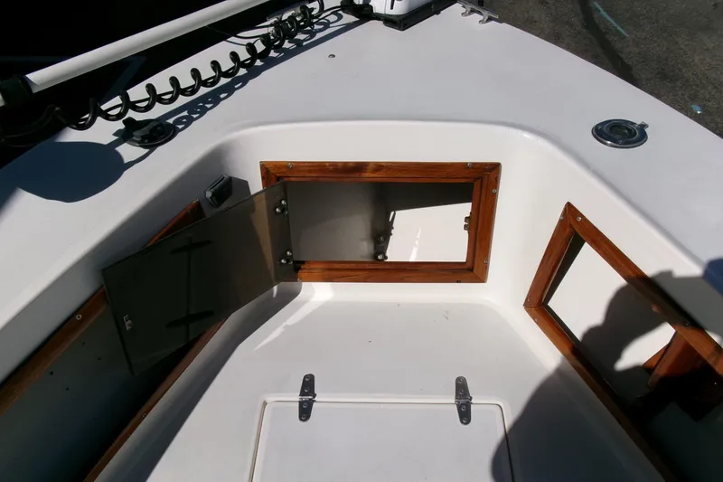 Slide: The Image of 1989 SeaCraft SC 20 Classic boat interior with open storage compartment and wooden trim. - 8