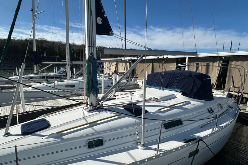 Slide: The Image of 2001 Beneteau 381 sailboat docked at marina under clear blue sky. - 10