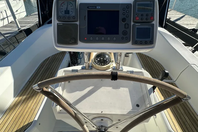 Slide: The Image of Steering console of a 2001 Beneteau 381 sailboat with navigation instruments. - 12