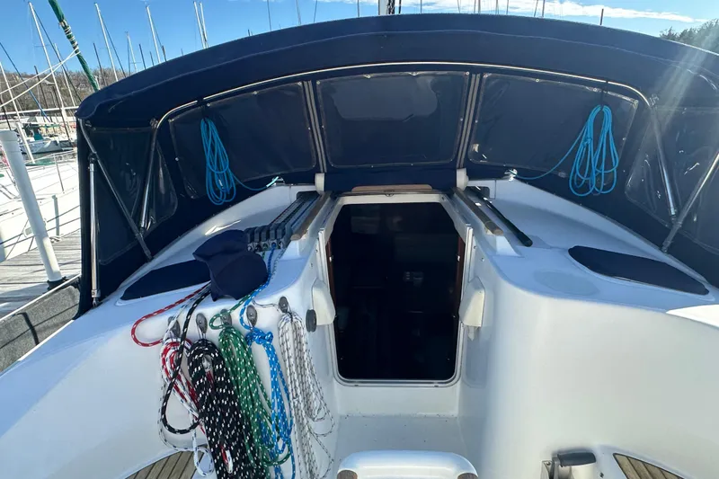 Slide: The Image of Cockpit of 2001 Beneteau 381 sailboat with ropes and covered seating area. - 13