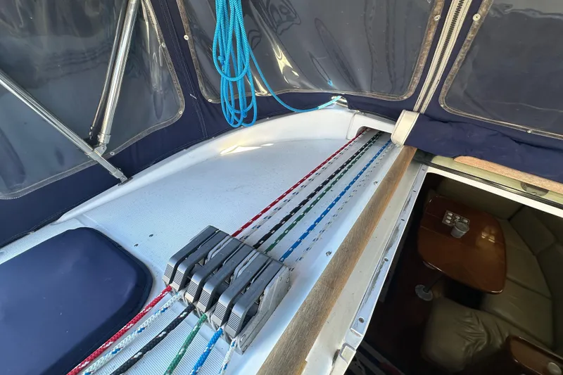 Slide: The Image of Cockpit view of 2001 Beneteau 381 sailboat with colorful ropes and cabin entrance. - 16