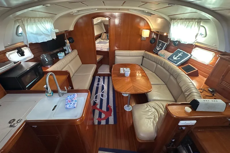 Slide: The Image of Interior of 2001 Beneteau 381 yacht with cozy seating and nautical decor. - 17