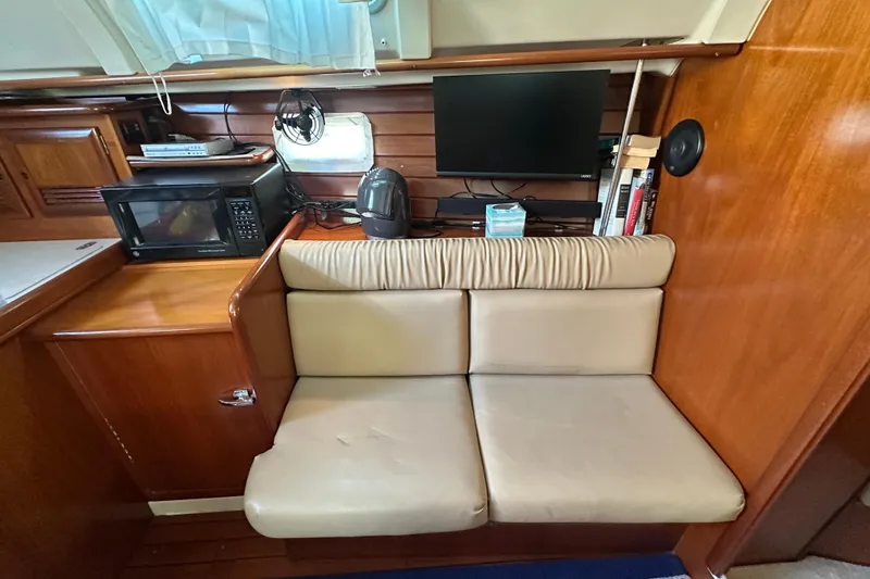 Slide: The Image of Interior of 2001 Beneteau 381 yacht with seating, microwave, and TV. - 21