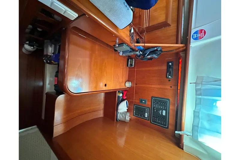 Slide: The Image of Interior of 2001 Beneteau 381 sailboat with wooden cabinetry and control panels. - 25