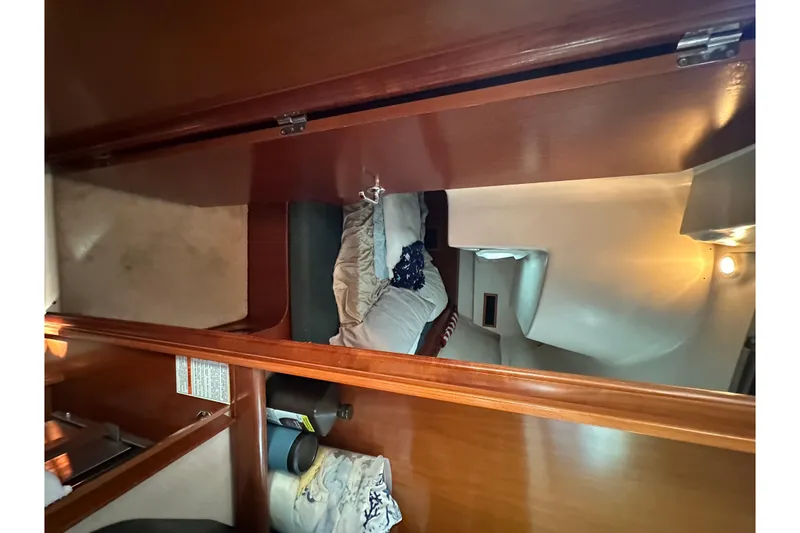 Slide: The Image of Interior cabin of 2001 Beneteau 381 sailboat with wooden finish and cozy bedding. - 27