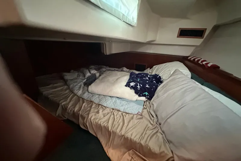 Slide: The Image of Cozy cabin interior of 2001 Beneteau 381 sailboat with bedding and pillows. - 29