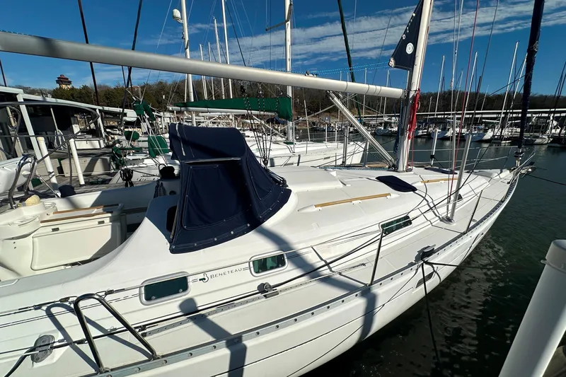 Slide: The Image of 2001 Beneteau 381 sailboat docked in marina, featuring sleek design and white hull. - 3