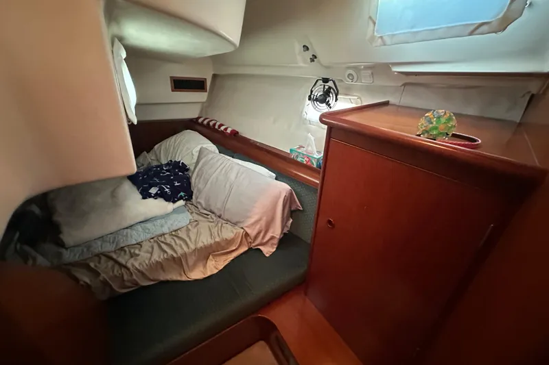 Slide: The Image of Cozy cabin interior of 2001 Beneteau 381 sailboat with bed and wooden cabinetry. - 30