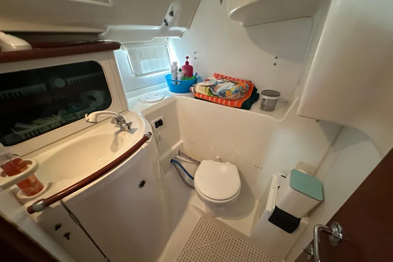 Slide: The Image of Bathroom interior of 2001 Beneteau 381 yacht, featuring sink, toilet, and storage. - 31