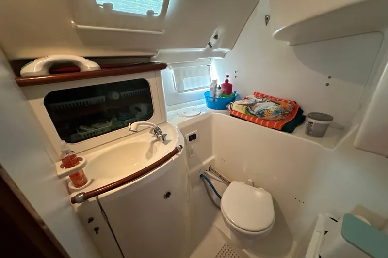Slide: The Image of Bathroom interior of 2001 Beneteau 381 yacht, featuring sink, toilet, and storage. - 32