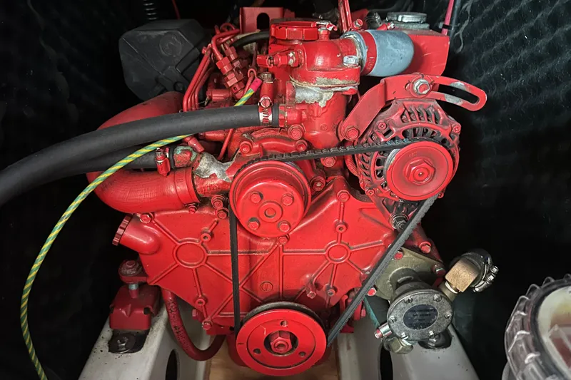 Slide: The Image of Red engine of a 2001 Beneteau 381 sailboat, showcasing mechanical components. - 34