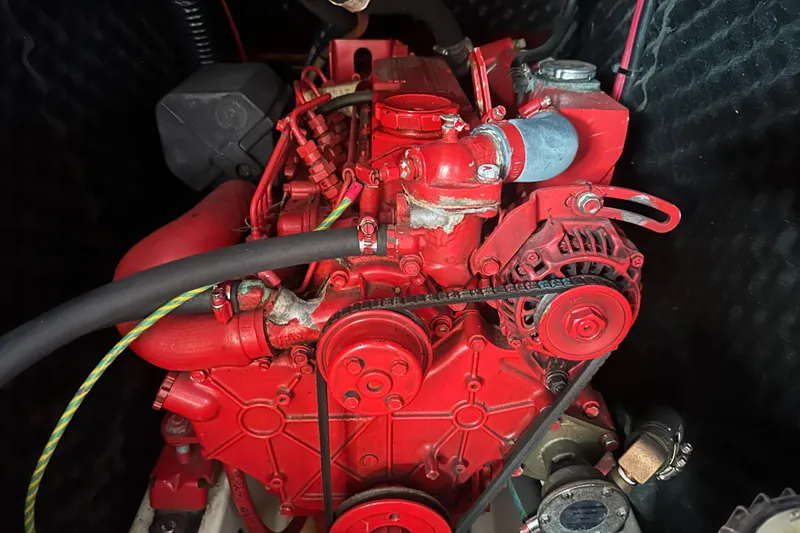 Slide: The Image of Red engine of a 2001 Beneteau 381 sailboat, showcasing intricate mechanical components. - 35