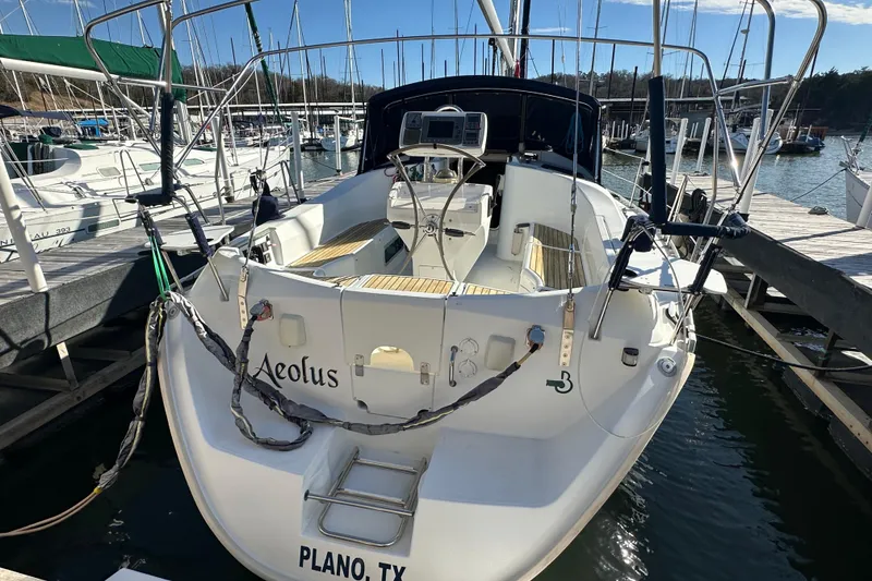 Slide: The Image of 2001 Beneteau 381 sailboat docked, rear view, named "Aeolus," located in Plano, TX. - 5
