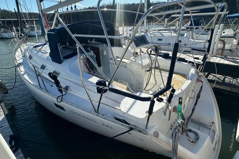 Slide: The Image of 2001 Beneteau Oceanis 381 sailboat docked at marina, featuring sleek design and spacious deck. - 7