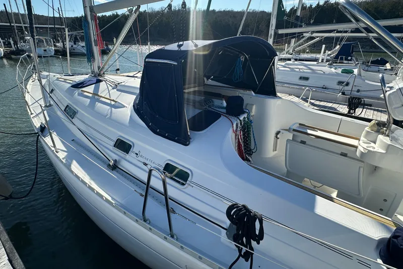 Slide: The Image of 2001 Beneteau 381 sailboat docked, featuring sleek design and spacious cockpit. - 8