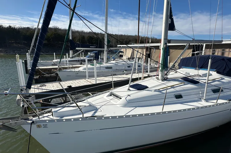 Slide: The Image of 2001 Beneteau 381 sailboats docked at a marina under clear skies. - 9