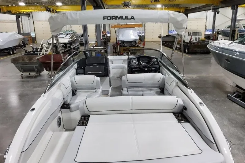 Slide: The Image of 2026 Formula 240 Bowrider boat with white interior in a showroom. - 22
