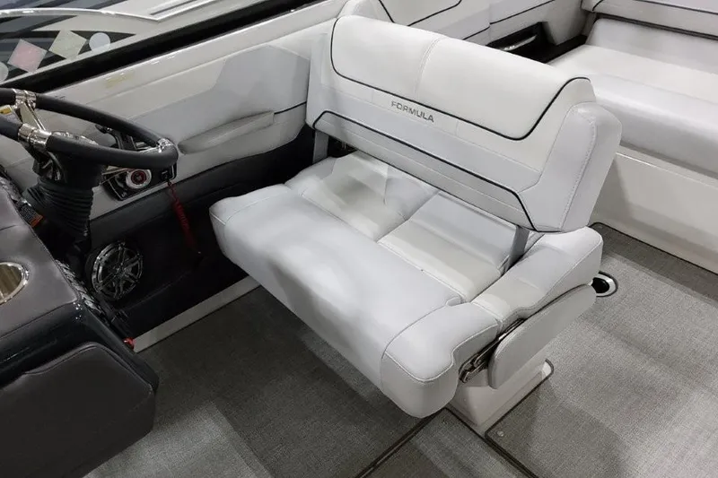 Slide: The Image of 2026 Formula 240 Bowrider interior with white leather seating and steering wheel. - 28