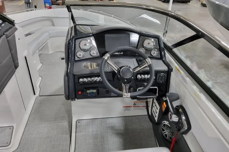 Slide: The Image of 2026 Formula 240 Bowrider boat cockpit with steering wheel and control panel. - 29