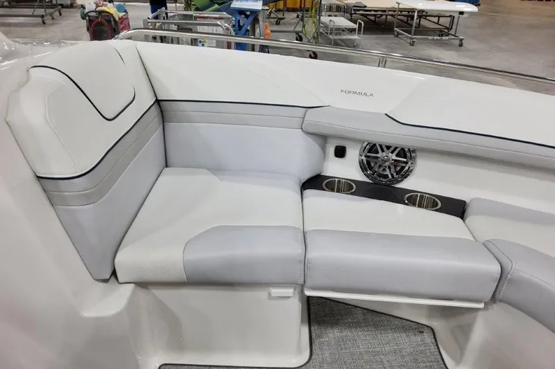 Slide: The Image of 2026 Formula 240 Bowrider interior seating with speaker and cup holders. - 34