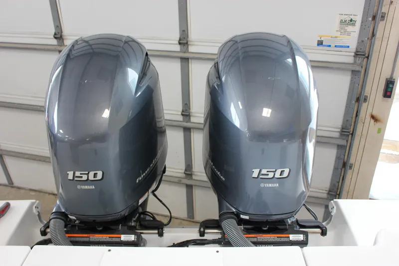Slide: The Image of Twin Yamaha 150 engines on a 2022 Sea Hunt Gamefish 25 boat in a garage. - 19
