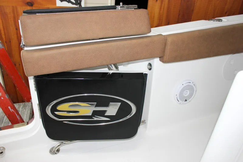 Slide: The Image of 2022 Sea Hunt Gamefish 25 interior with brown seating and SH logo. - 20