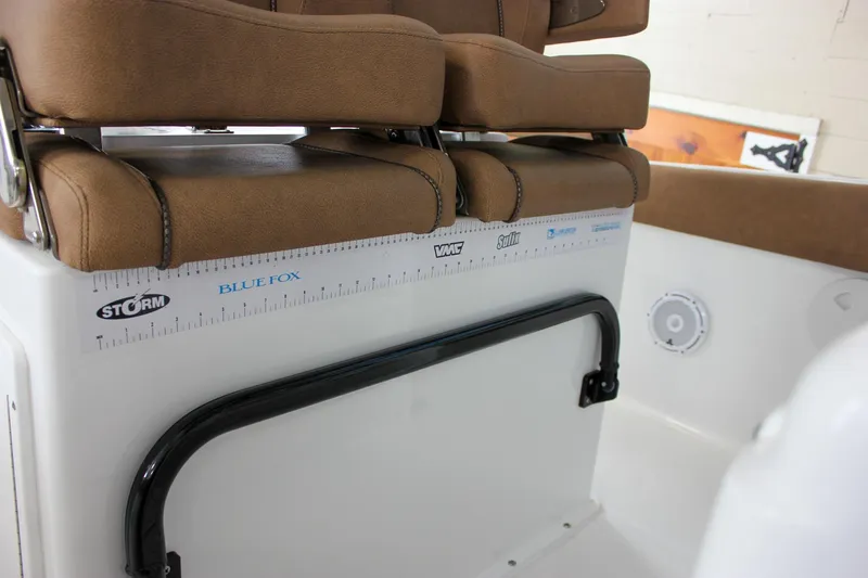 Slide: The Image of 2022 Sea Hunt Gamefish 25 boat interior with brown seating and measurement ruler. - 28