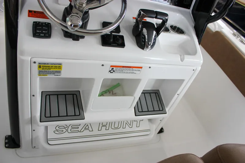 Slide: The Image of 2022 Sea Hunt Gamefish 25 console with steering wheel and controls. - 31