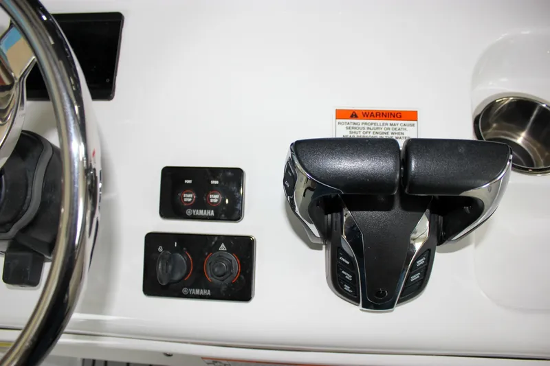 Slide: The Image of 2022 Sea Hunt Gamefish 25 boat controls with Yamaha throttle and warning label. - 37