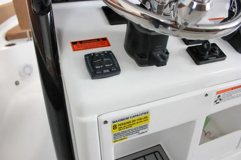 Slide: The Image of 2022 Sea Hunt Gamefish 25 helm with steering wheel and capacity warning label. - 38