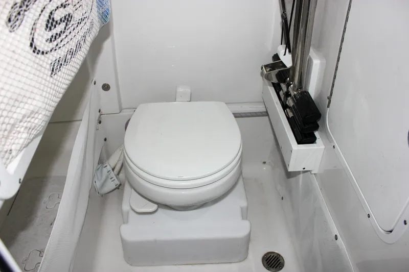 Slide: The Image of 2022 Sea Hunt Gamefish 25 boat interior with compact marine toilet. - 43