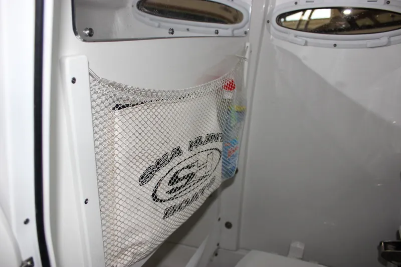 Slide: The Image of Interior of 2022 Sea Hunt Gamefish 25 boat with storage net and portholes. - 44