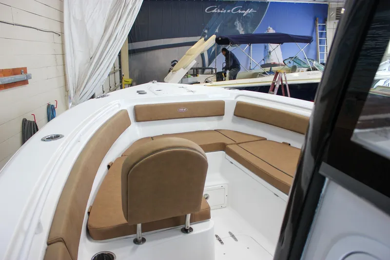 Slide: The Image of 2022 Sea Hunt Gamefish 25 boat interior with tan seating in a showroom. - 45