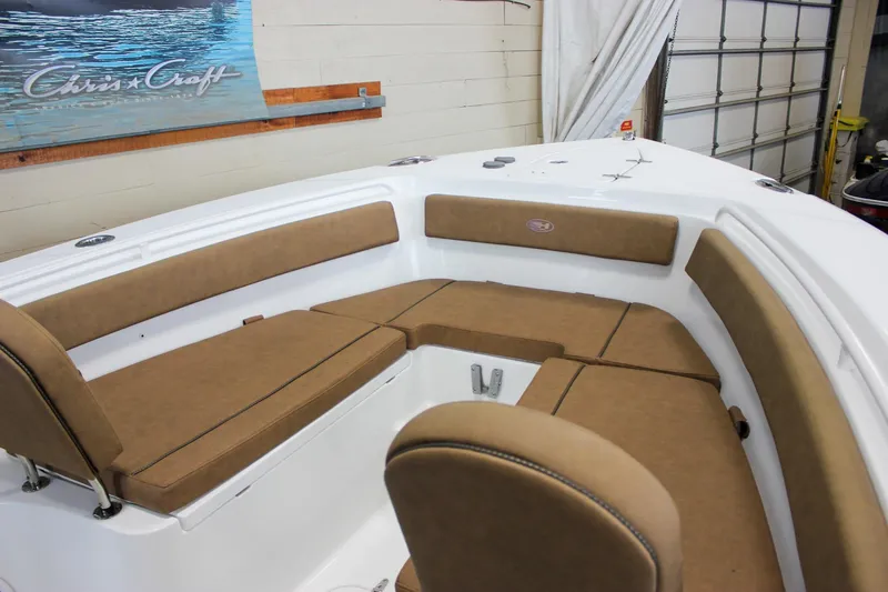 Slide: The Image of 2022 Sea Hunt Gamefish 25 boat interior with tan cushioned seating. - 47