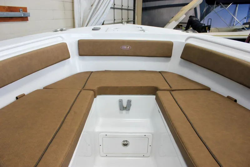 Slide: The Image of 2022 Sea Hunt Gamefish 25 boat interior with brown cushioned seating. - 48