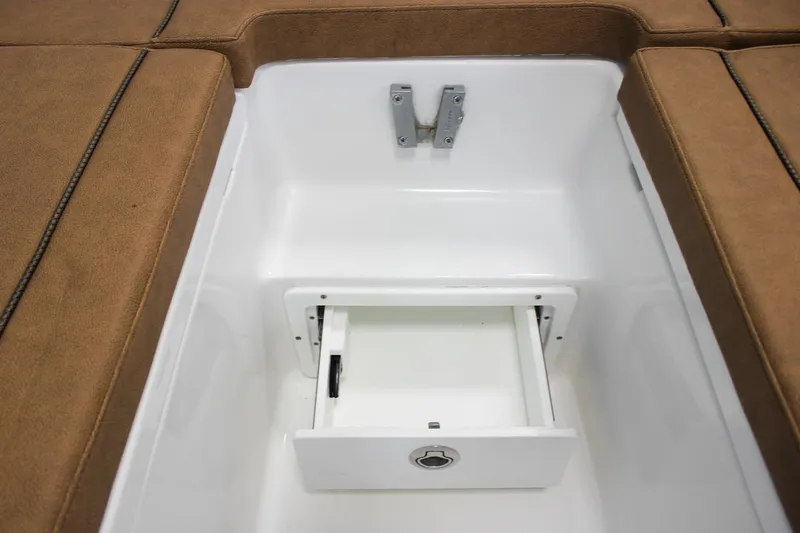 Slide: The Image of 2022 Sea Hunt Gamefish 25 boat storage compartment with brown cushioned seating. - 49