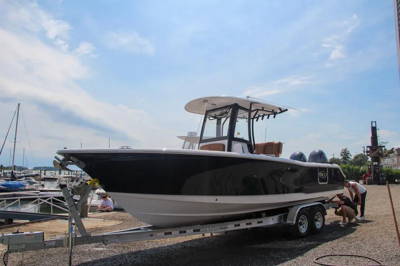 Slide: The Image of 2022 Sea Hunt Gamefish 25 boat on trailer at marina under clear sky. - 5