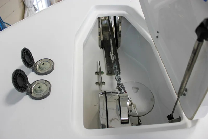 Slide: The Image of 2022 Sea Hunt Gamefish 25 anchor locker with open hatch and chain mechanism. - 50