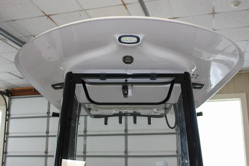 Slide: The Image of 2022 Sea Hunt Gamefish 25 boat T-top with LED lights in a garage setting. - 52